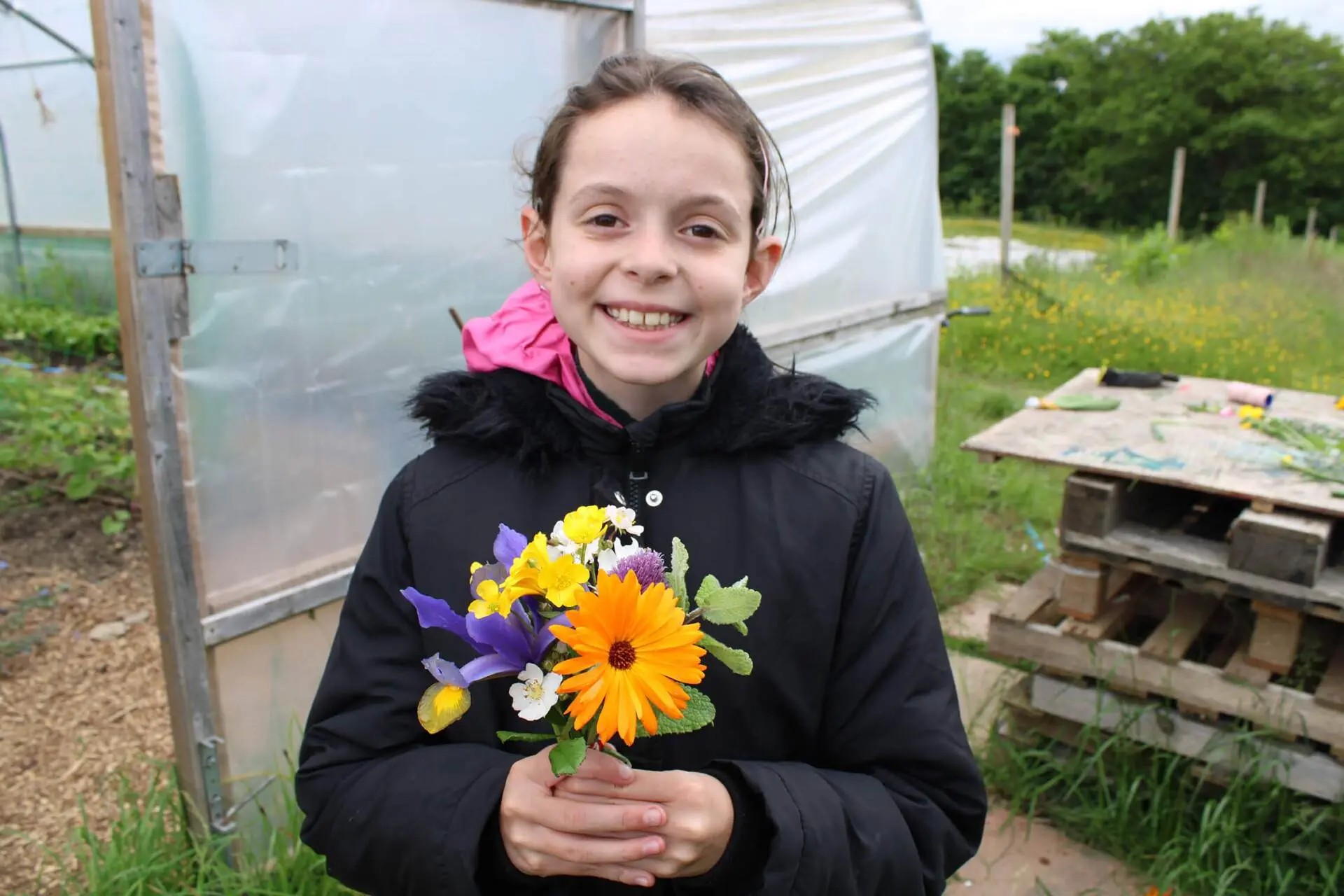 School pupil holding fresh flower bouquet